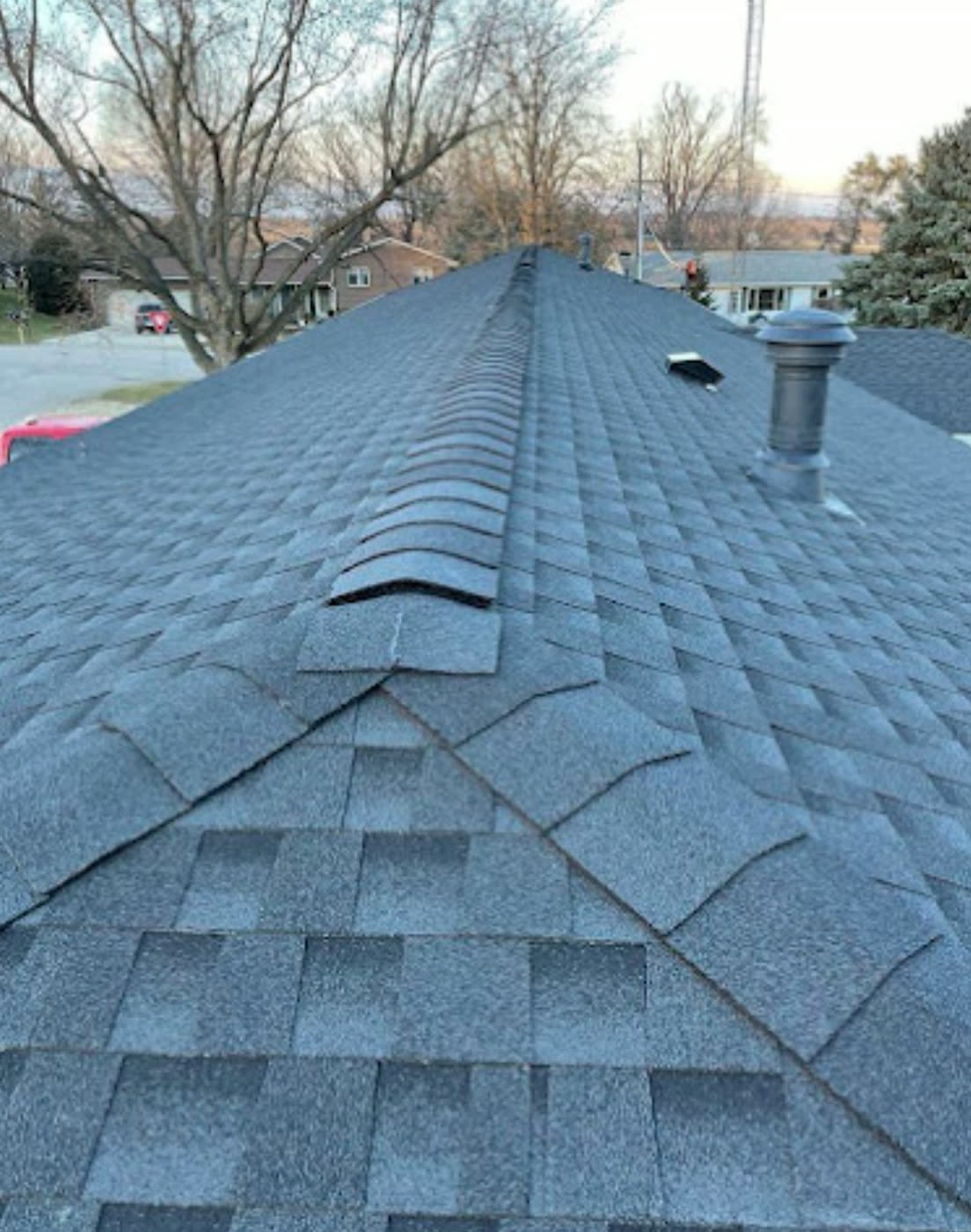 Finished shingle roof with new ridge cap